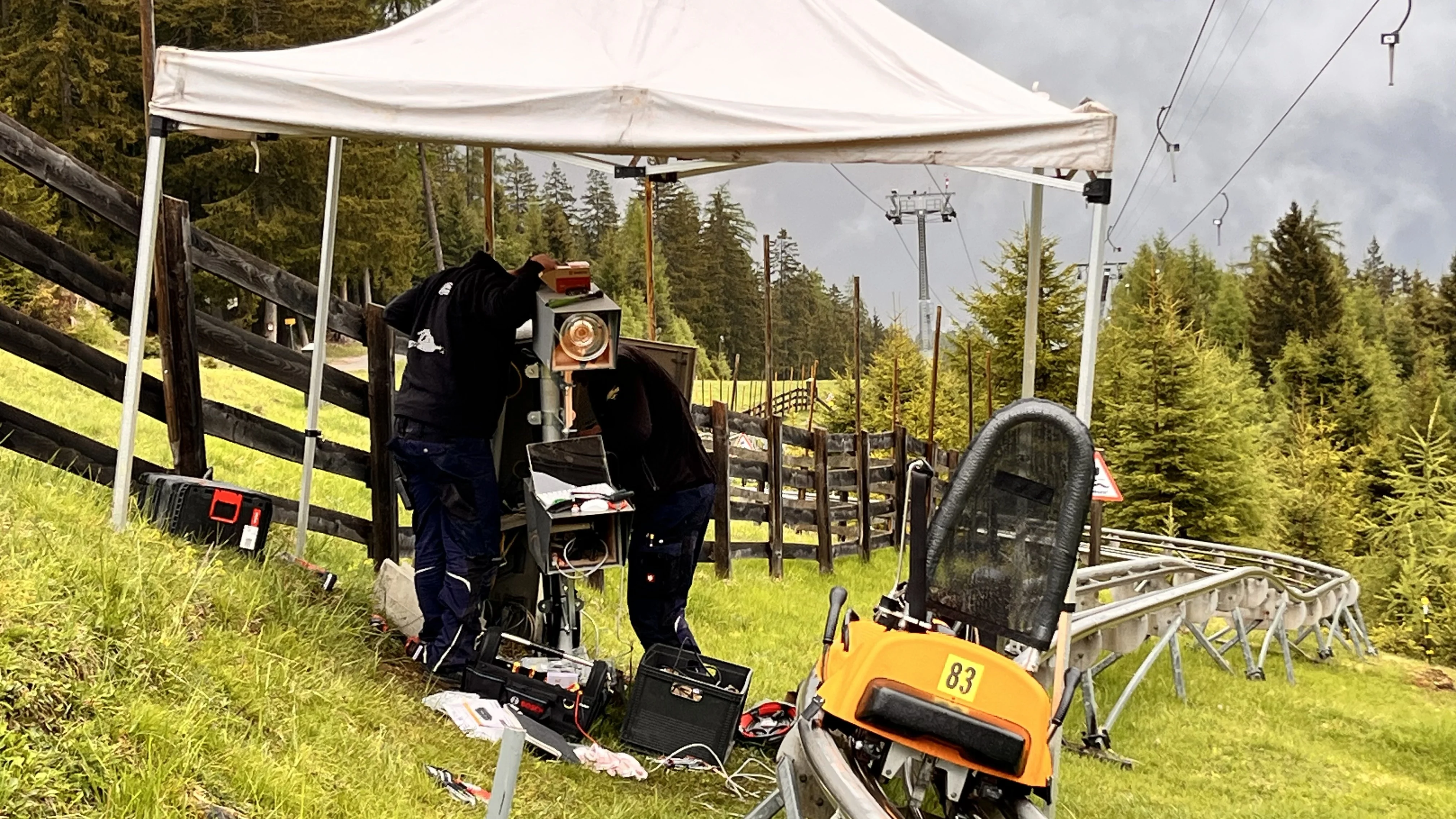 Liftpictures technicians installing an onride photo system camera at an alpine coaster attraction
